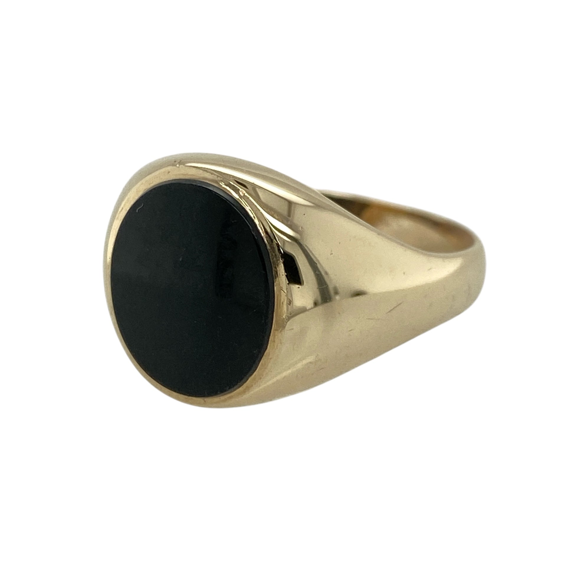 Make a bold and timeless statement with this pre-owned 9ct yellow gold onyx set oval signet ring—an iconic piece that combines classic style with strong visual presence.

Design: This signet ring features a large oval onyx stone measuring approximately 14mm by 12mm, creating a striking focal point with its deep black, polished finish. The traditional signet style offers a bold and masculine silhouette.