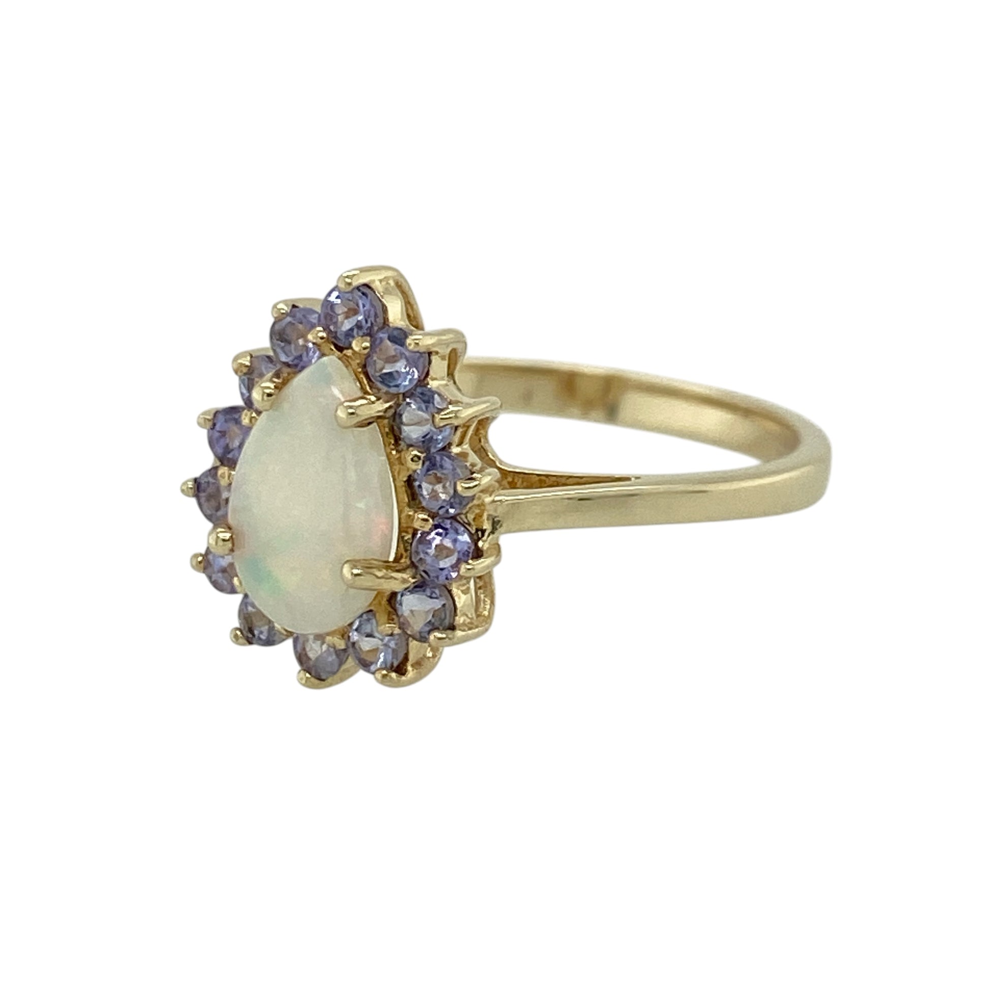 Add a soft play of colour and elegant sparkle to your jewellery collection with this pre-owned 9ct yellow gold opalique and tanzanite set teardrop cluster ring—perfect for both everyday wear and special occasions.

Design: This ring features a central teardrop opalique stone measuring approximately 6mm by 9mm, surrounded by small round tanzanite gemstones that create a delicate and eye-catching cluster effect.