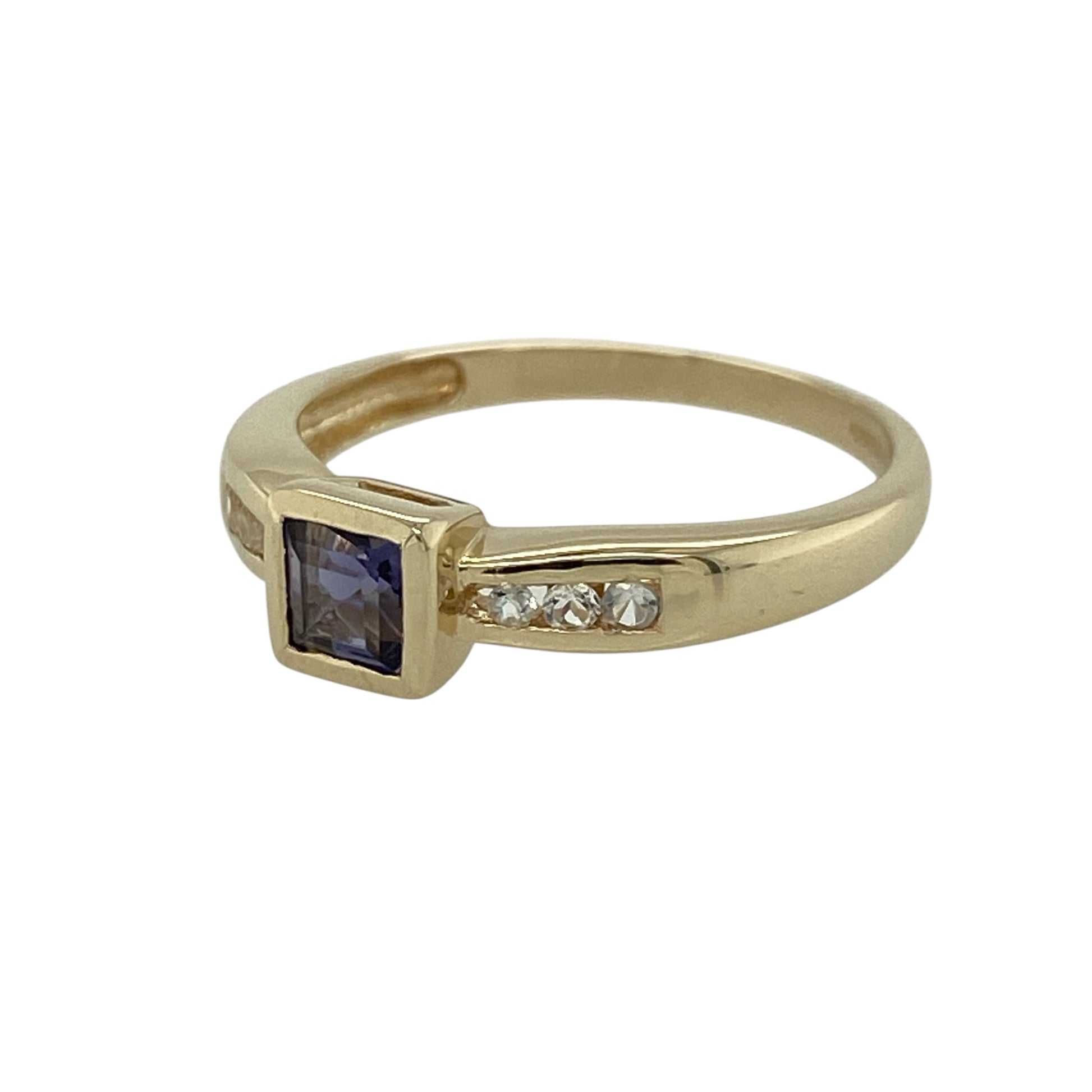 Add a subtle touch of colour and sparkle to your jewellery collection with this pre-owned 9ct yellow gold iolite and cubic zirconia set ring—an elegant and versatile piece perfect for everyday wear.

Design: This ring features a central iolite coloured stone measuring approximately 4mm by 4mm, creating a delicate focal point, complemented by sparkling cubic zirconia stones set along the shoulders for added brilliance.