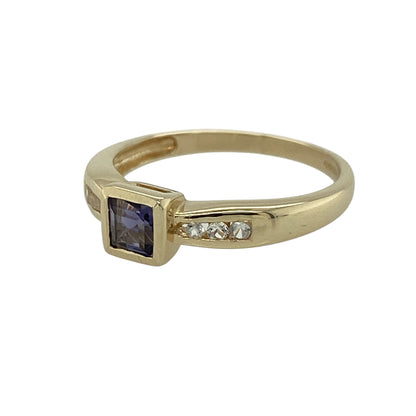 Add a subtle touch of colour and sparkle to your jewellery collection with this pre-owned 9ct yellow gold iolite and cubic zirconia set ring—an elegant and versatile piece perfect for everyday wear.

Design: This ring features a central iolite coloured stone measuring approximately 4mm by 4mm, creating a delicate focal point, complemented by sparkling cubic zirconia stones set along the shoulders for added brilliance.