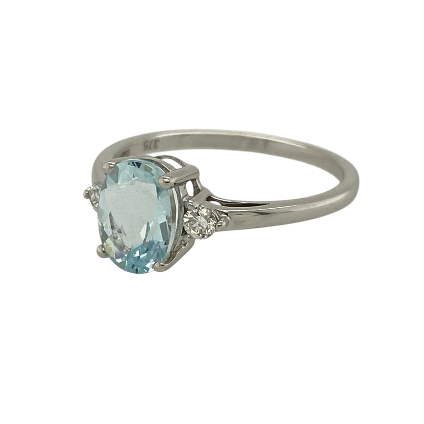 Add a touch of soft colour and elegant sparkle to your jewellery collection with this pre-owned 9ct white gold diamond and aquamarine set ring—an understated yet eye-catching piece perfect for everyday wear or special occasions.

Design: This ring features a central oval aquamarine measuring approximately 8mm by 6mm, flanked by a sparkling diamond on either side to create a balanced and refined three-stone look.