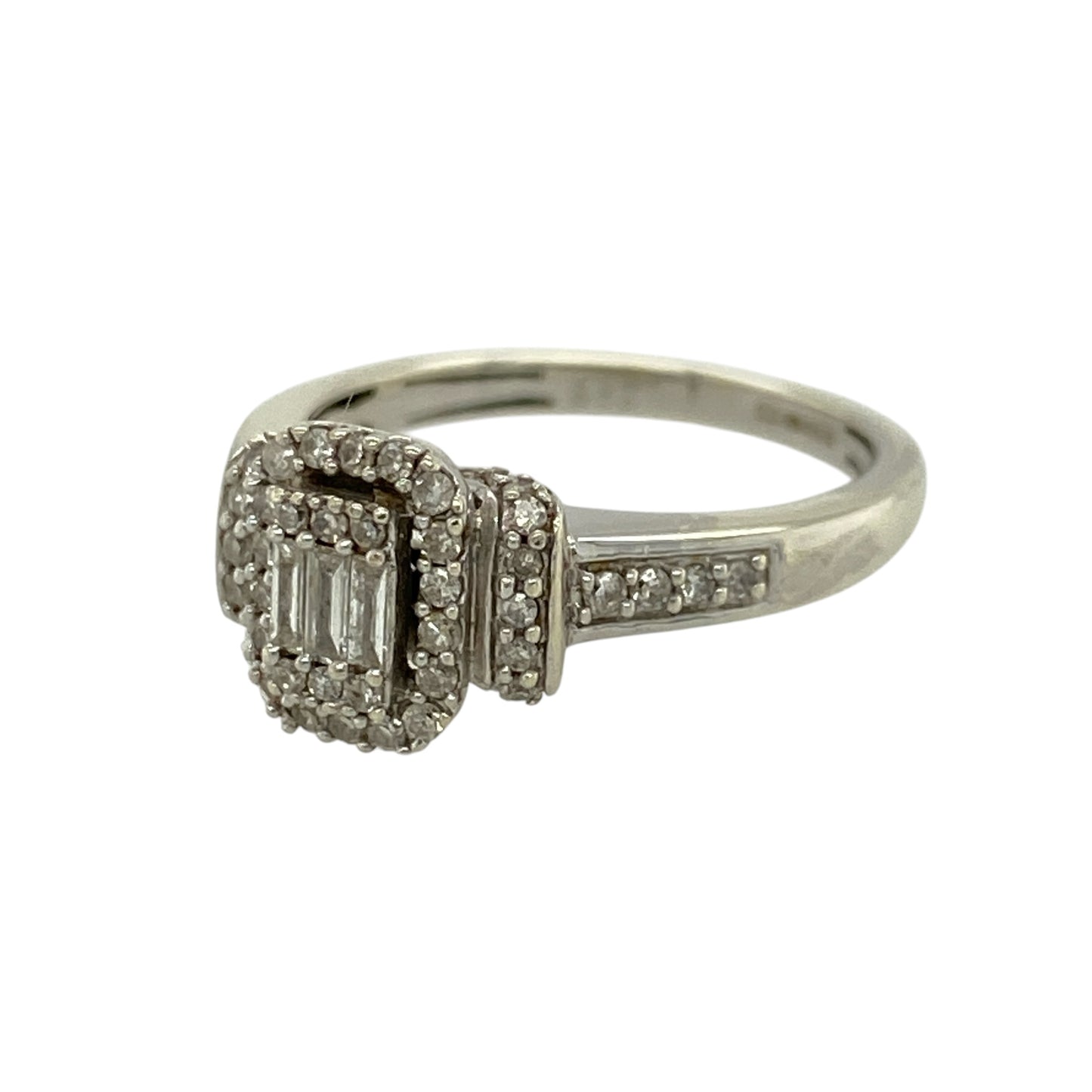 Add elegant sparkle and modern design to your jewellery collection with this pre-owned 9ct white gold diamond set rectangle halo ring—an eye-catching piece perfect for special occasions or everyday wear.

Design: This ring features a striking rectangular halo front measuring approximately 9mm high, set with three baguette-cut diamonds at the centre, surrounded and complemented by multiple brilliant-cut diamonds extending onto the shoulders for added brilliance.