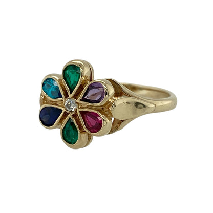 Add a vibrant burst of colour to your jewellery collection with this pre-owned 9ct yellow gold gemstone set flower ring—an eye-catching and playful piece perfect for everyday wear or special occasions.

Design: This ring features a striking flower design with a 12mm high front, with petals set in a mix of blue, green, red, and purple stones, creating a bright and lively display. A sparkling cubic zirconia sits at the centre, adding extra brilliance.