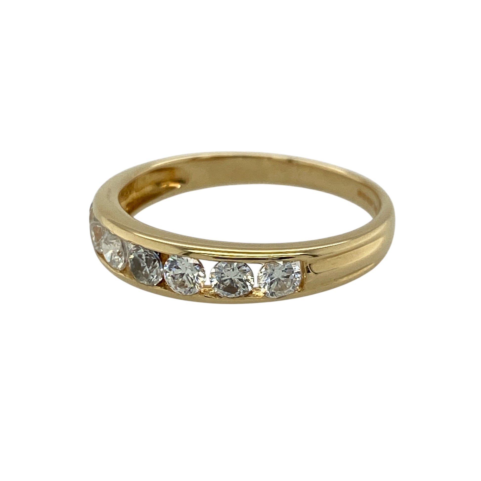 Add classic sparkle and timeless style to your jewellery collection with this pre-owned 18ct yellow gold cubic zirconia set band ring—an elegant and versatile piece perfect for everyday wear.

Design: This band ring features a 4mm wide front, set with seven round cubic zirconia stones arranged in a neat and balanced row, creating a refined and eye-catching look.
Material: Made from 18-carat yellow gold, the polished finish enhances the warm golden tone while complementing the brilliance of the stones.