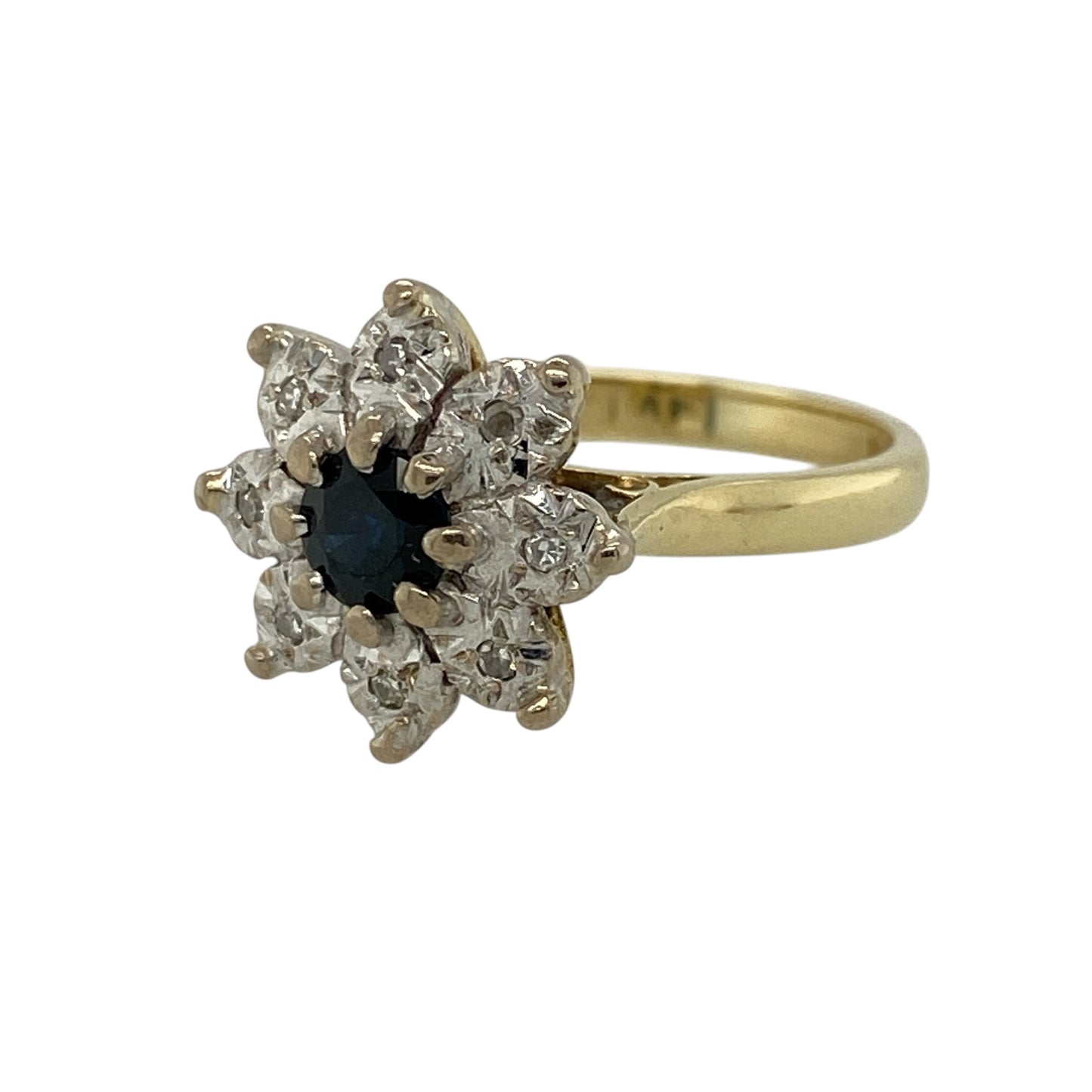 Add timeless elegance and striking colour to your jewellery collection with this pre-owned 18ct yellow gold diamond and sapphire set flower cluster ring—an eye-catching piece perfect for special occasions or everyday luxury.

Design: This ring features a beautiful flower cluster design with a 13mm high front, centred with a sapphire measuring approximately 5mm in diameter, surrounded by petal-like diamonds set in white gold for added brilliance and contrast.