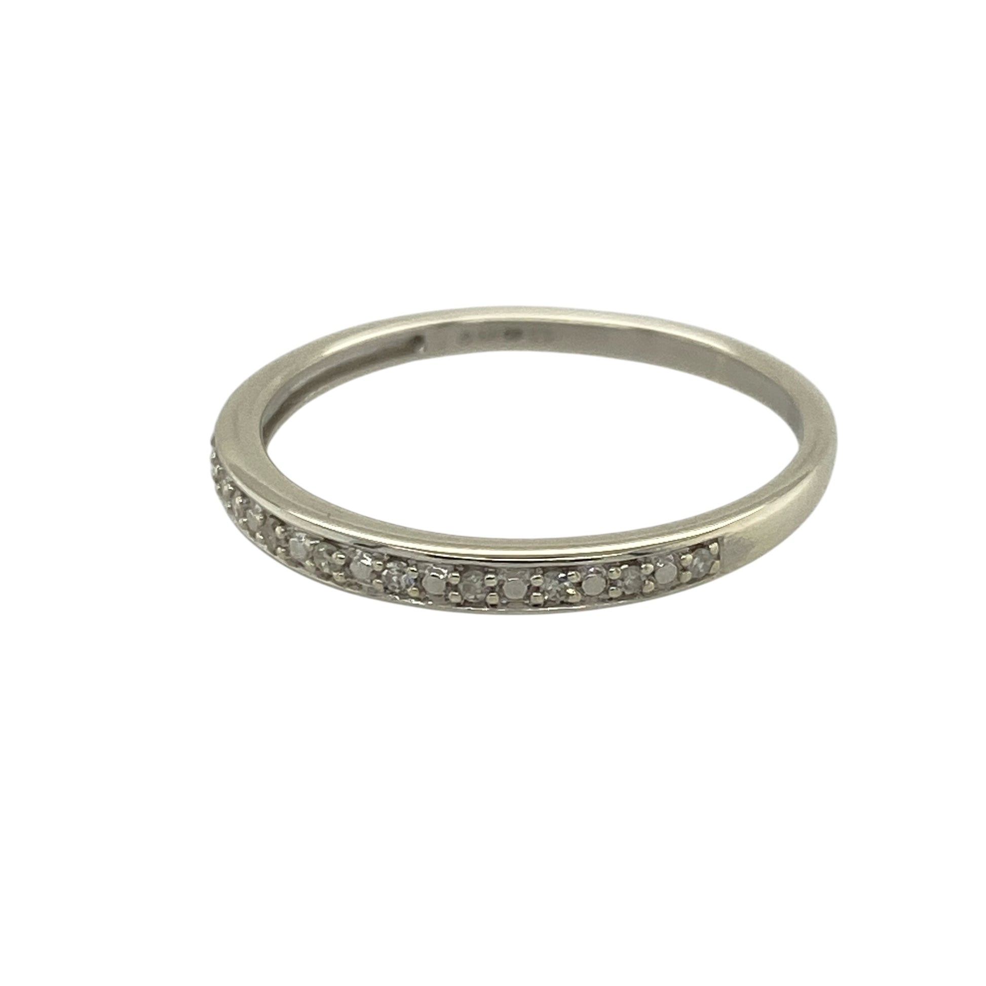 Add subtle sparkle and modern elegance to your jewellery collection with this pre-owned 9ct white gold diamond set band ring—an understated and versatile piece perfect for everyday wear.

Design: This band ring features a slim 2mm wide front, set with delicate diamonds that create a refined and minimalist look across the finger.
Material: Made from 9-carat white gold, the polished finish enhances the brilliance of the diamonds while offering a sleek and contemporary appearance.