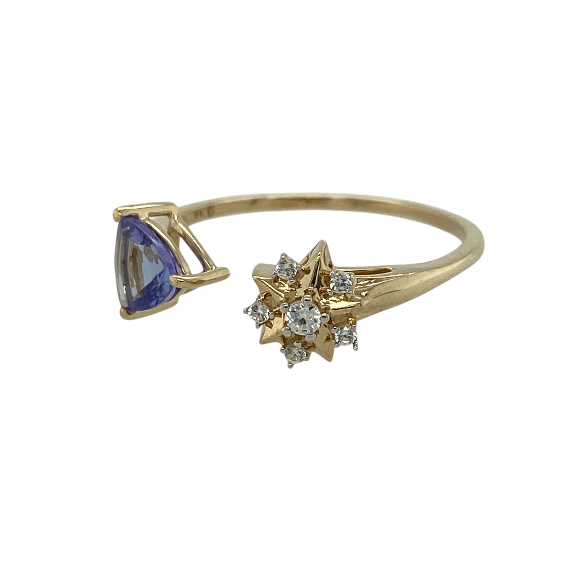 Add a modern twist of colour and sparkle to your jewellery collection with this pre-owned 9ct yellow gold tanzanite and cubic zirconia set torque style ring—an eye-catching and contemporary piece perfect for everyday wear.

Design: This ring features an open torque-style design, with one end set with a striking triangular tanzanite stone measuring approximately 6mm by 6mm by 6mm, and the other end finished with a sparkling cubic zirconia cluster for a balanced and unique look.