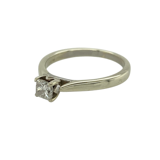 Add classic elegance and refined sparkle to your jewellery collection with this pre-owned 9ct white gold diamond set princess cut solitaire ring—an eye-catching piece perfect for any occasion.

Design: This ring features a single princess-cut diamond, offering clean lines and a contemporary square shape that creates a striking and timeless focal point.
Material: Made from 9-carat white gold, the polished finish enhances the brilliance of the diamond while giving the ring a sleek and modern appearance.