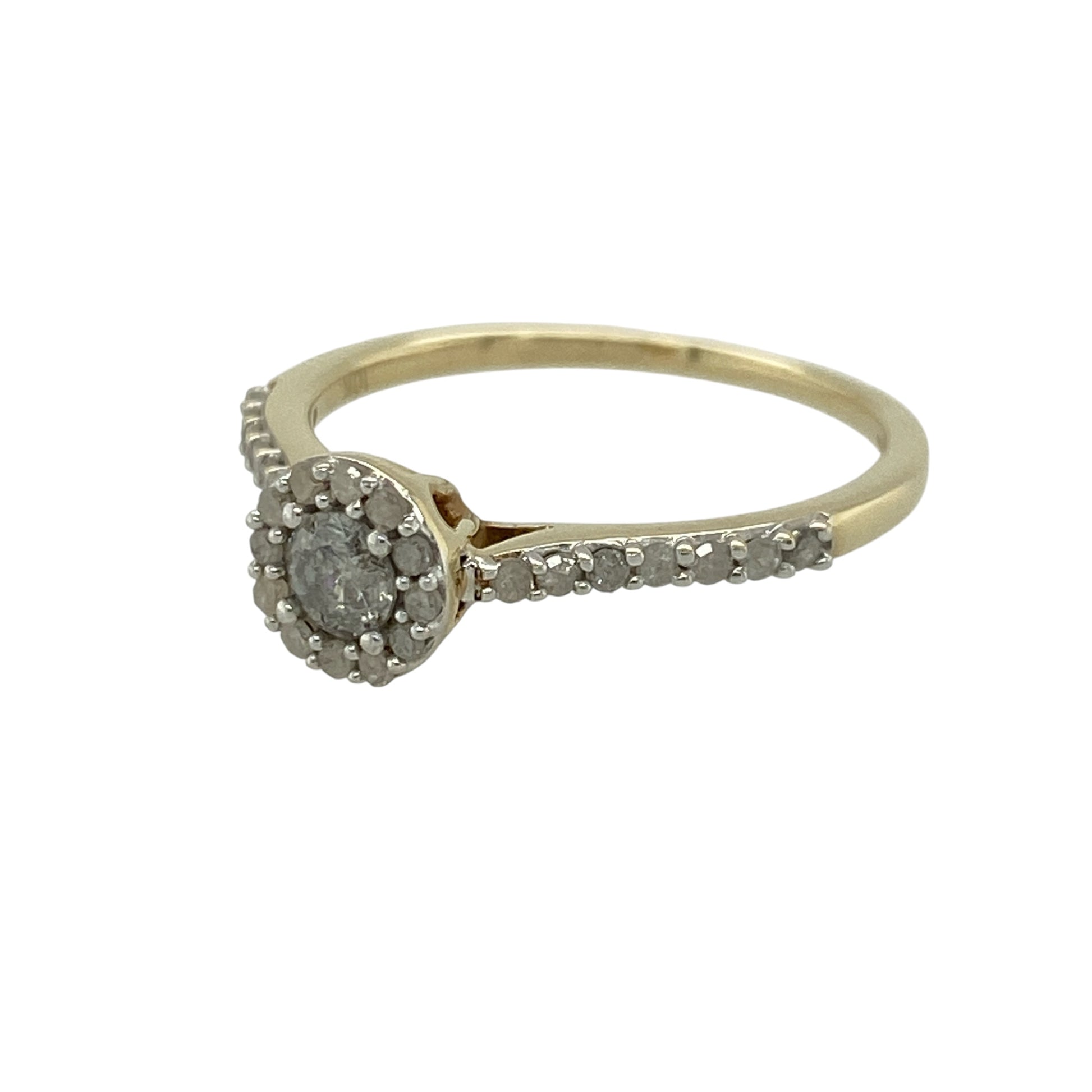 Add elegant sparkle and timeless style to your jewellery collection with this pre-owned 9ct yellow gold diamond set halo ring—an eye-catching piece perfect for special occasions or everyday wear.

Design: This ring features a central brilliant-cut diamond of approximately 0.25ct, surrounded by a halo of smaller diamonds that enhance its size and brilliance. Additional diamonds are set along the shoulders for extra sparkle.