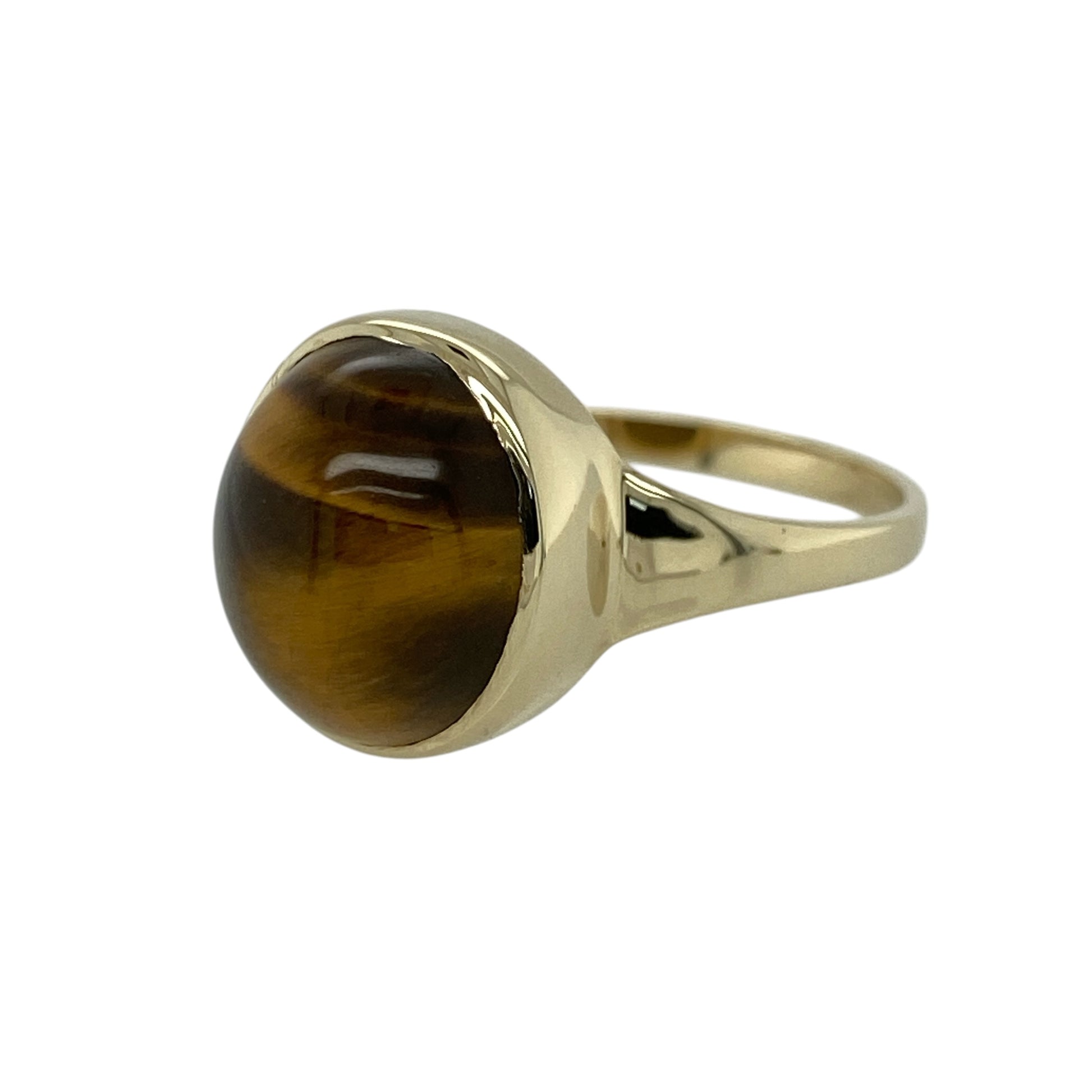 Bring warm earthy tones and bold character to your jewellery collection with this pre-owned 9ct yellow gold tiger’s eye ring, featuring a striking natural gemstone and classic statement styling—ideal for everyday wear or standout occasions.

Design: The ring showcases an oval-shaped tiger’s eye measuring approximately 12mm by 10mm, displaying rich golden-brown bands with a natural chatoyant shimmer that catches the light beautifully.