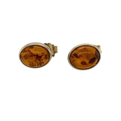 Add warm natural tones to your jewellery collection with these pre-owned 9ct yellow gold amber stud earrings, featuring rich colour and timeless simplicity—perfect for everyday wear or a subtle statement look.

Design: The earrings feature oval-shaped amber stones measuring approximately 9mm by 7mm each, displaying beautiful golden hues with natural inclusions that catch the light.