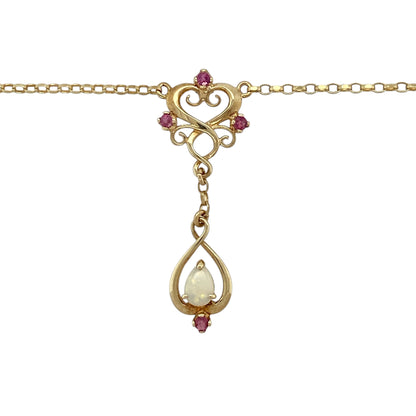 Add elegant movement and a touch of colour to your jewellery collection with this pre-owned 9ct yellow gold ruby and opalique fancy swirl drop necklace, featuring a graceful design and eye-catching detail—perfect for special occasions or refined everyday wear.

Design: The necklace features a decorative swirl drop pendant set with ruby and opalique-style stones, creating a flowing and feminine look with subtle colour contrast.