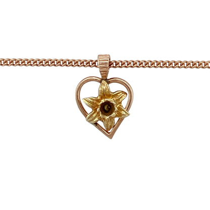 Add a touch of Welsh heritage and delicate beauty to your jewellery collection with this pre-owned 9ct yellow and rose gold daffodil heart pendant necklace, featuring a symbolic floral design—perfect for everyday wear or meaningful gifting.

Design: The pendant is styled as a heart adorned with a daffodil motif, symbolising Wales and new beginnings, with a soft blend of yellow and rose tones creating a charming and feminine look.