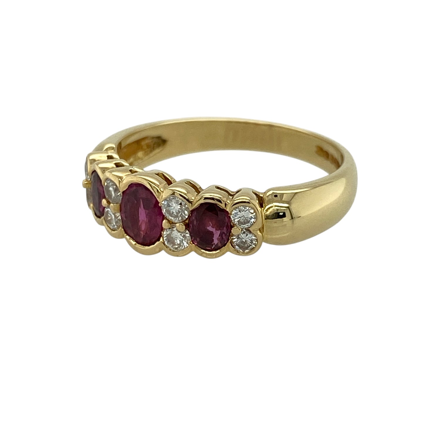 Add timeless elegance and rich colour to your jewellery collection with this pre-owned 18ct yellow gold diamond and ruby trilogy ring, featuring classic gemstones and refined sparkle—perfect for special occasions or everyday luxury.

Design: The ring showcases three oval rubies, with the centre stone measuring approximately 5mm by 4mm and the two side stones approximately 4mm by 3mm each, complemented by two diamonds set between the rubies for added brilliance.