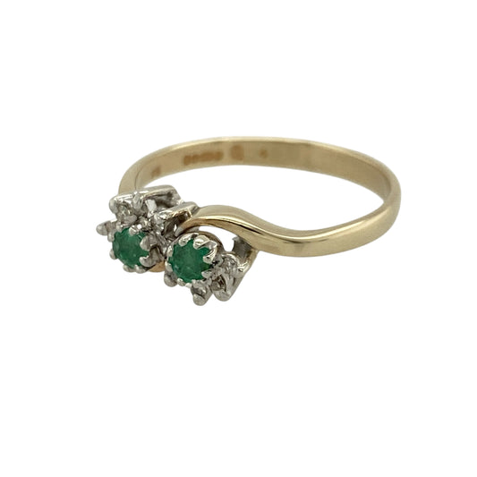 Add vibrant colour and elegant sparkle to your jewellery collection with this pre-owned 9ct yellow gold diamond and emerald double cluster ring, featuring a classic design with a unique twist—perfect for special occasions or refined everyday wear.

Design: The ring features two round emeralds, each approximately 3mm, with each stone surrounded by a cluster of small diamonds, creating a balanced and eye-catching double cluster effect.