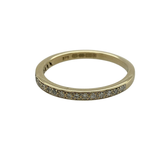 Add delicate sparkle to your jewellery collection with this pre-owned 9ct yellow gold diamond set band ring, featuring a slim and elegant design—perfect for everyday wear or stacking with other rings.

Design: The ring features a fine 2mm band set with diamonds totalling approximately 0.11ct, offering a subtle yet eye-catching shimmer across the surface.
Material: Made from 9ct yellow gold, the polished finish enhances the warmth of the metal while complementing the brilliance of the diamonds.