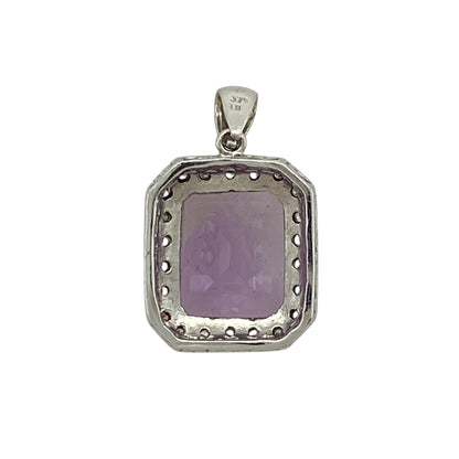 Add bold colour and refined sparkle to your jewellery collection with this pre-owned 9ct white gold diamond and amethyst pendant, featuring a striking centre stone and elegant surround—perfect for special occasions or statement everyday wear.

Design: The pendant showcases a rectangular amethyst measuring approximately 12mm by 10mm, surrounded by small diamonds that enhance its rich purple tones and create a classic cluster effect.