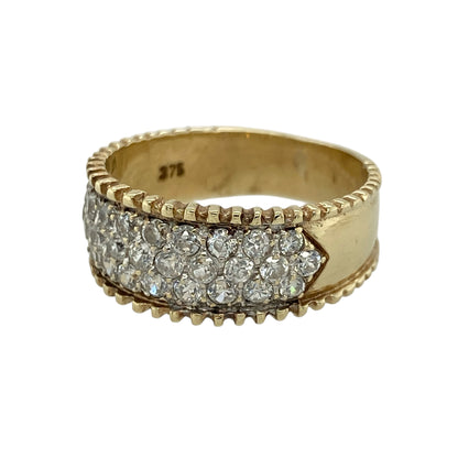 Add bold sparkle to your jewellery collection with this pre-owned 9ct yellow gold cubic zirconia set band ring, featuring a wide design with brilliant multi-row detailing—perfect for statement wear or special occasions.

Design: The ring features multiple round cubic zirconia stones arranged in three rows across the front, creating a dazzling and eye-catching display of sparkle.
