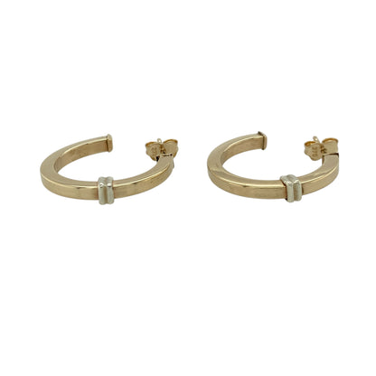 Add modern elegance to your jewellery collection with these pre-owned 9ct yellow and white gold squared half hoop earrings, featuring a clean geometric design and two-tone finish—perfect for everyday wear or refined styling.

Design: The earrings feature a squared half hoop shape, offering a contemporary twist on a classic hoop style with a structured and stylish profile.
