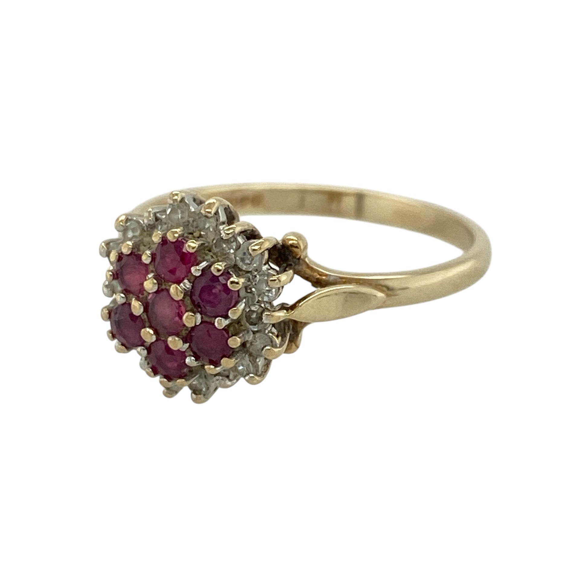 Add rich colour and elegant sparkle to your jewellery collection with this pre-owned 9ct yellow gold diamond and ruby cluster ring, featuring a classic halo design—perfect for special occasions or refined everyday wear.

Design: The ring features a cluster of seven rubies at the centre, forming a vibrant focal point, surrounded by a halo of small diamonds that enhance the colour and add brilliant sparkle.
