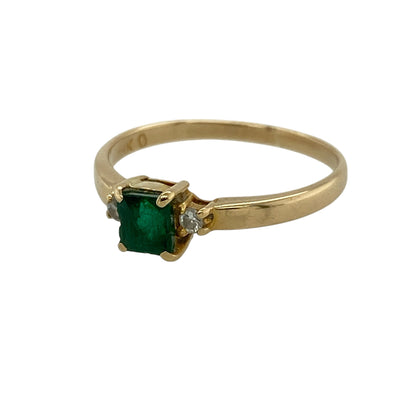 Add timeless elegance and vibrant colour to your jewellery collection with this pre-owned 18ct yellow gold diamond and emerald trilogy ring, featuring a classic three-stone design—perfect for special occasions or everyday luxury.

Design: The ring showcases a square-cut emerald measuring approximately 4mm by 4mm at its centre, flanked by a diamond on either side for a balanced and sophisticated look.