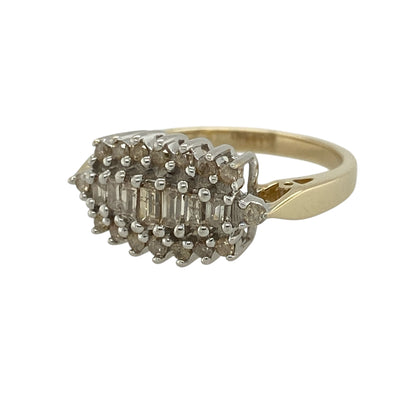 Add bold sparkle and timeless elegance to your jewellery collection with this pre-owned 9ct yellow gold diamond cluster ring, featuring a striking design with impressive brilliance—perfect for special occasions or statement wear.

Design: The ring features a cluster of baguette-cut diamonds at the centre, surrounded by brilliant-cut diamonds, creating a layered and eye-catching display of sparkle.