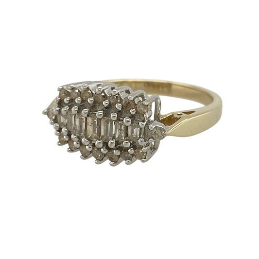 Add bold sparkle and timeless elegance to your jewellery collection with this pre-owned 9ct yellow gold diamond cluster ring, featuring a striking design with impressive brilliance—perfect for special occasions or statement wear.

Design: The ring features a cluster of baguette-cut diamonds at the centre, surrounded by brilliant-cut diamonds, creating a layered and eye-catching display of sparkle.