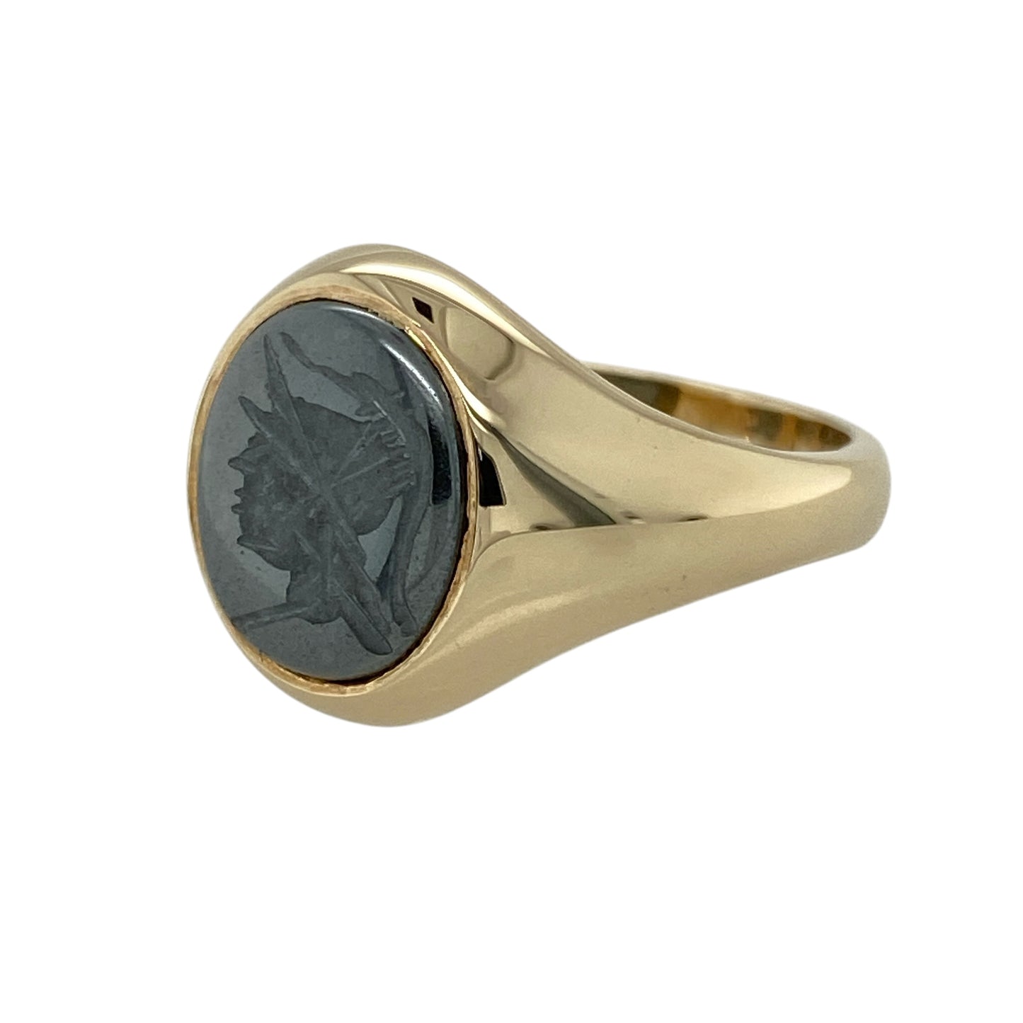 Add bold character and classic style to your jewellery collection with this pre-owned 9ct yellow gold hematite centurion signet ring, featuring a striking engraved design—perfect for everyday wear or a standout statement piece.

Design: The ring showcases an oval hematite stone measuring approximately 12mm by 10mm, engraved with a centurion motif that adds a distinctive and powerful visual appeal.