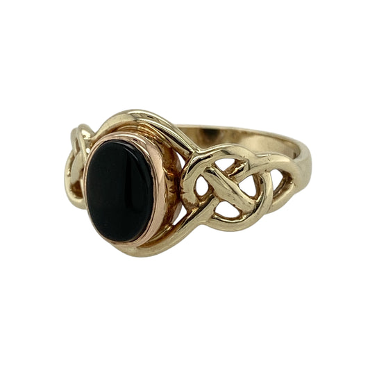 Bring heritage style and bold contrast to your collection with this pre-owned 9ct yellow and rose gold onyx set Clogau Celtic knot ring—a meaningful design rich in symbolism and timeless elegance.

Design: The ring features a 8mm by 6mm deep black onyx stone framed by an intricate Celtic knot design, blending warm yellow and rose gold tones in true Clogau style.
Material: Made from 9-carat yellow and rose gold, the polished finish enhances both the dark sheen of the onyx and the detailed knotwork.
