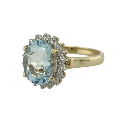 Add soft colour and elegant sparkle to your jewellery collection with this pre-owned 9ct yellow gold diamond and aquamarine cluster ring, featuring a classic design with a luminous centre—perfect for special occasions or refined everyday wear.

Design: The ring showcases an oval aquamarine measuring approximately 10mm by 8mm at its centre, surrounded by sparkling diamonds that enhance its delicate blue tone and create a timeless cluster effect.