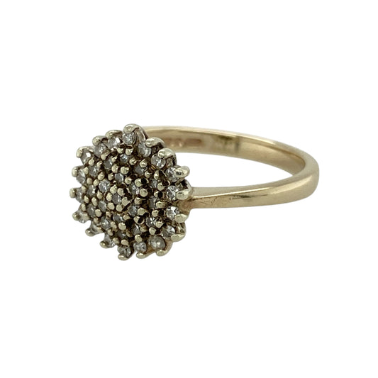 Add timeless sparkle to your jewellery collection with this pre-owned 9ct yellow gold diamond cluster ring, featuring a classic design with elegant brilliance—perfect for special occasions or everyday wear.

Design: The ring showcases a diamond cluster at the centre, creating a bright and eye-catching focal point with a balanced and timeless appeal.
Material: Made from 9ct yellow gold, the polished finish enhances the warm tone of the metal while complementing the sparkle of the diamonds.
