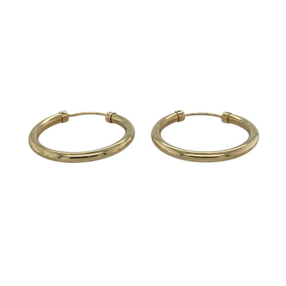 Add timeless simplicity to your jewellery collection with these pre-owned 9ct yellow gold plain hoop earrings, featuring a classic design and polished finish—perfect for everyday wear or effortless styling.

Design: The earrings feature a traditional hoop shape measuring approximately 22mm in diameter, offering a clean and versatile look that suits any style.
Material: Made from 9ct yellow gold, the polished finish enhances the warm tone of the metal, giving a refined and classic appearance.