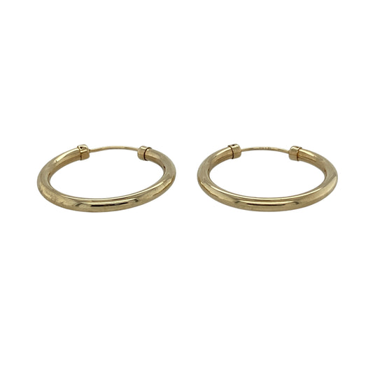 Add timeless simplicity to your jewellery collection with these pre-owned 9ct yellow gold plain hoop earrings, featuring a classic design and polished finish—perfect for everyday wear or effortless styling.

Design: The earrings feature a traditional hoop shape measuring approximately 22mm in diameter, offering a clean and versatile look that suits any style.
Material: Made from 9ct yellow gold, the polished finish enhances the warm tone of the metal, giving a refined and classic appearance.
