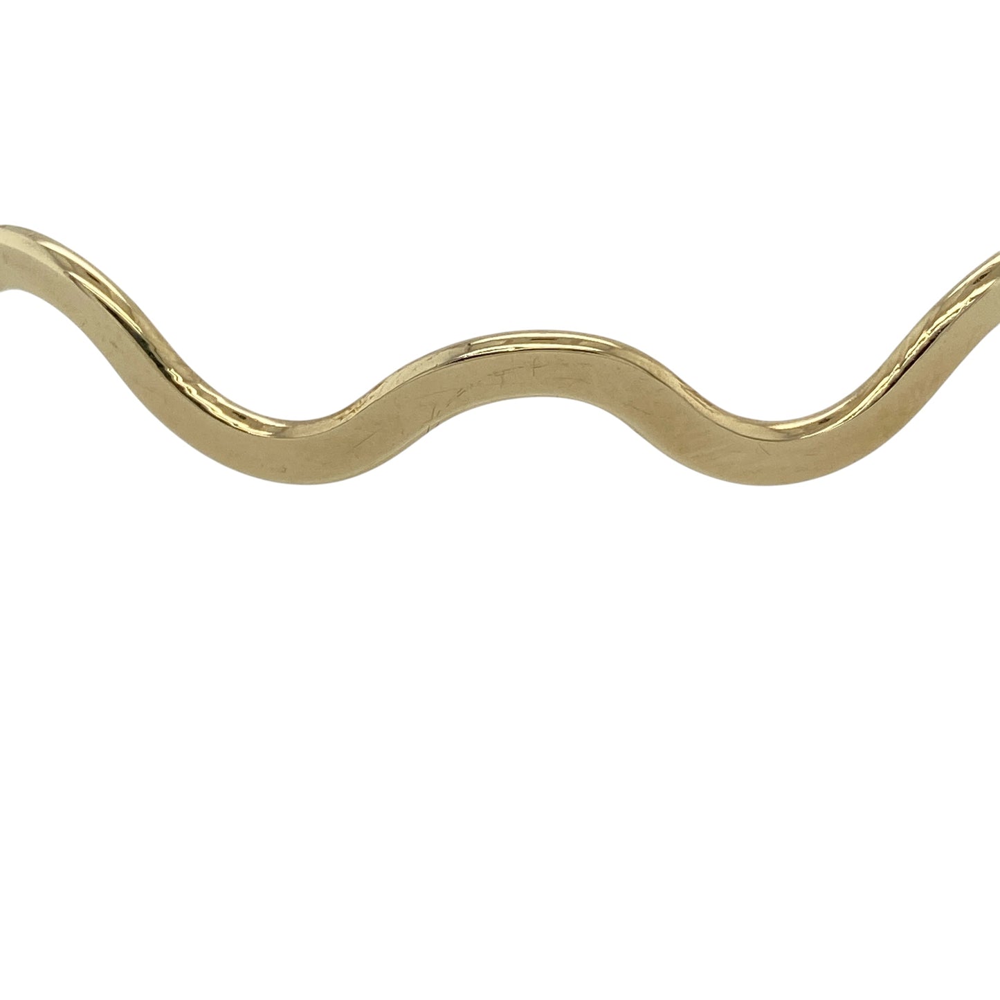 Add a touch of flowing elegance to your jewellery collection with this pre-owned 9ct yellow gold wave bangle, featuring a unique design with timeless appeal—perfect for everyday wear or stacking.

Design: The bangle features a gently wavy form, creating a fluid and eye-catching look that adds subtle movement and character.
Material: Made from 9ct yellow gold, the polished finish enhances the warm tone of the metal while highlighting the curved design.