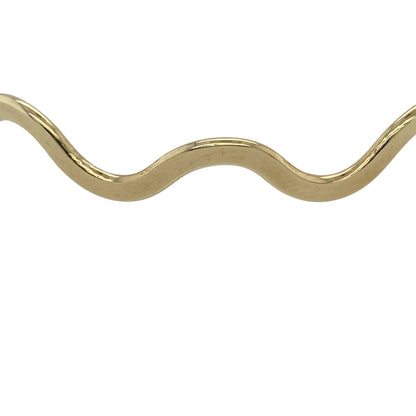 Add a touch of flowing elegance to your jewellery collection with this pre-owned 9ct yellow gold wave bangle, featuring a unique design with timeless appeal—perfect for everyday wear or stacking.

Design: The bangle features a gently wavy form, creating a fluid and eye-catching look that adds subtle movement and character.
Material: Made from 9ct yellow gold, the polished finish enhances the warm tone of the metal while highlighting the curved design.