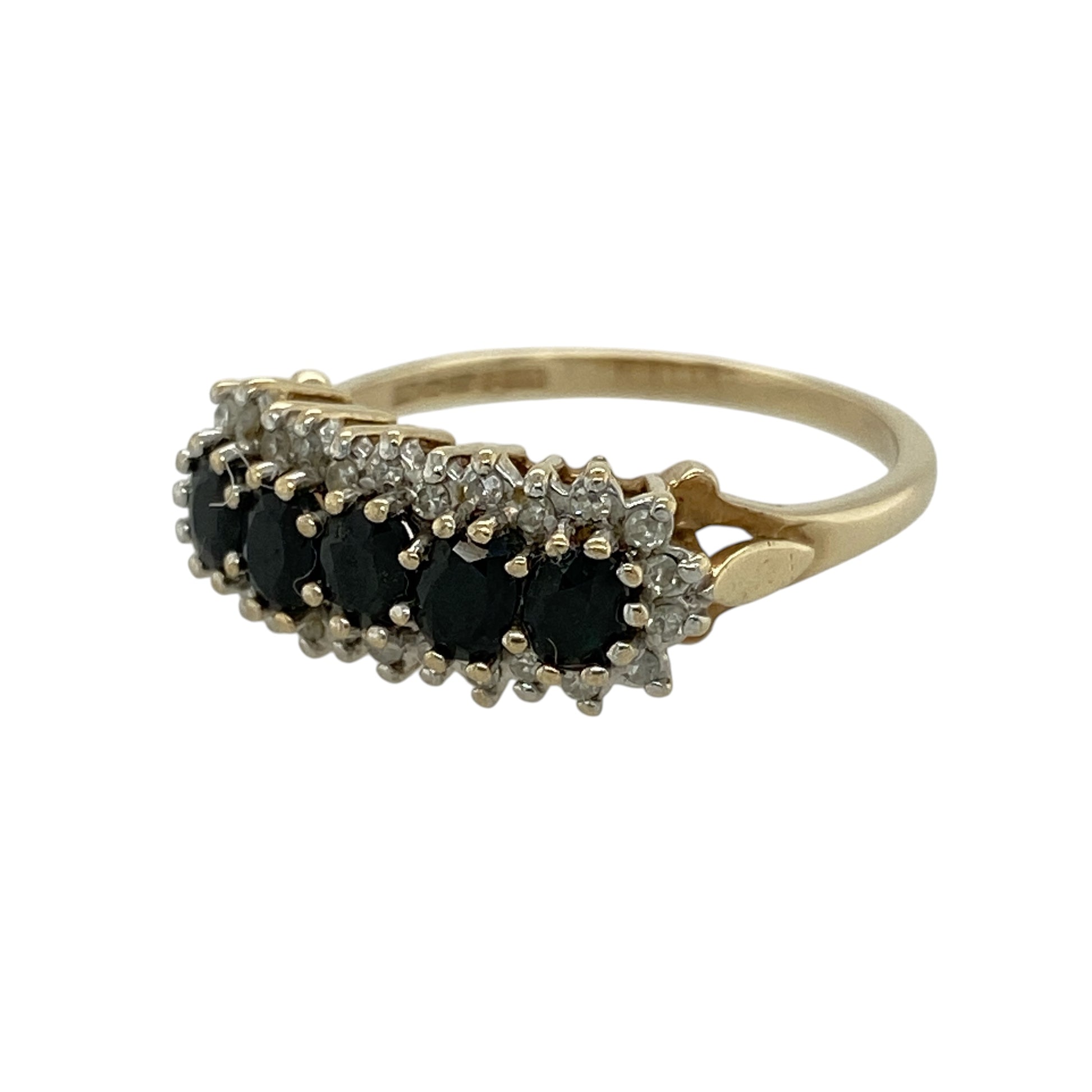 Add vibrant colour and elegant sparkle to your jewellery collection with this pre-owned 9ct yellow gold diamond and sapphire cluster band ring, featuring a bold and eye-catching design—perfect for special occasions or everyday wear.

Design: The ring showcases five oval sapphires across the front, each surrounded by sparkling diamonds, creating a beautiful multi-cluster effect with rich blue tones and brilliant contrast.