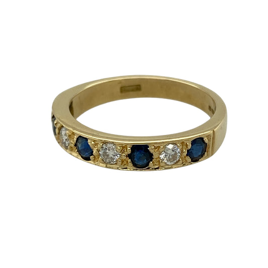 Add refined sparkle and timeless colour to your jewellery collection with this pre-owned 18ct yellow gold diamond and sapphire band ring, featuring a classic and elegant design—perfect for everyday wear or special occasions.

Design: The ring features a sleek band set with sapphires and diamonds, creating a beautiful contrast of deep blue tones and subtle brilliance across the front.