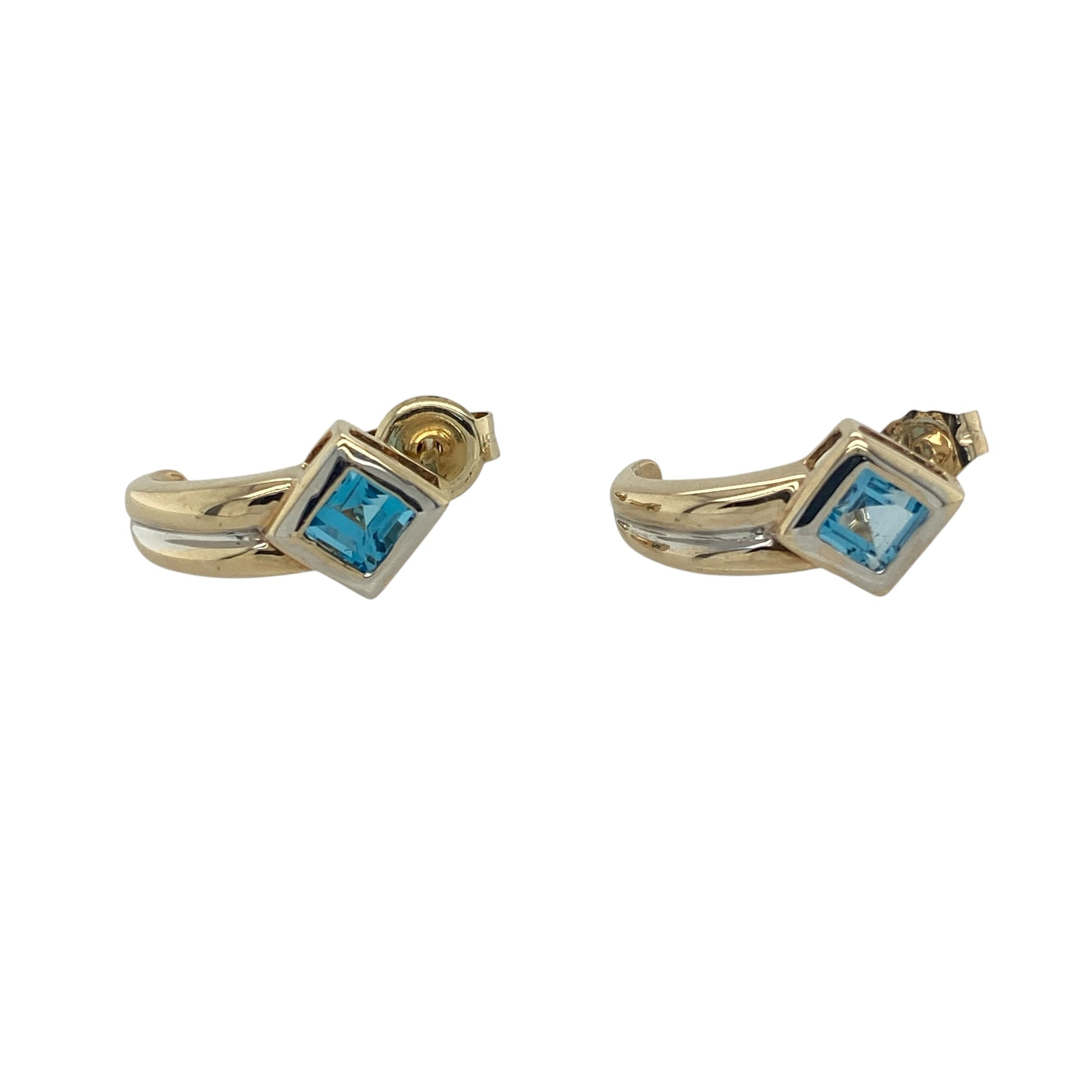Add a fresh pop of colour and contemporary elegance to your collection with these pre-owned 9ct yellow and white gold blue topaz curved stud earrings—perfect for everyday wear with a subtle touch of sparkle.

Design: The earrings feature a gently curved design, each set with a 3mm by 3mm square blue topaz stone, offering a soft yet eye-catching blue hue with a modern twist.