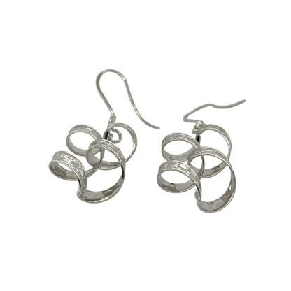 Add elegant movement and modern style to your collection with these pre-owned 9ct white gold patterned twisted drop earrings—an eye-catching pair with a sleek and contemporary finish.

Design: The earrings feature a twisted drop style with subtle patterned detailing, creating texture and fluidity that catches the light beautifully as they move.
Material: Made from 9-carat white gold, the cool-toned polished finish enhances the intricate twist design while offering a refined and versatile look.