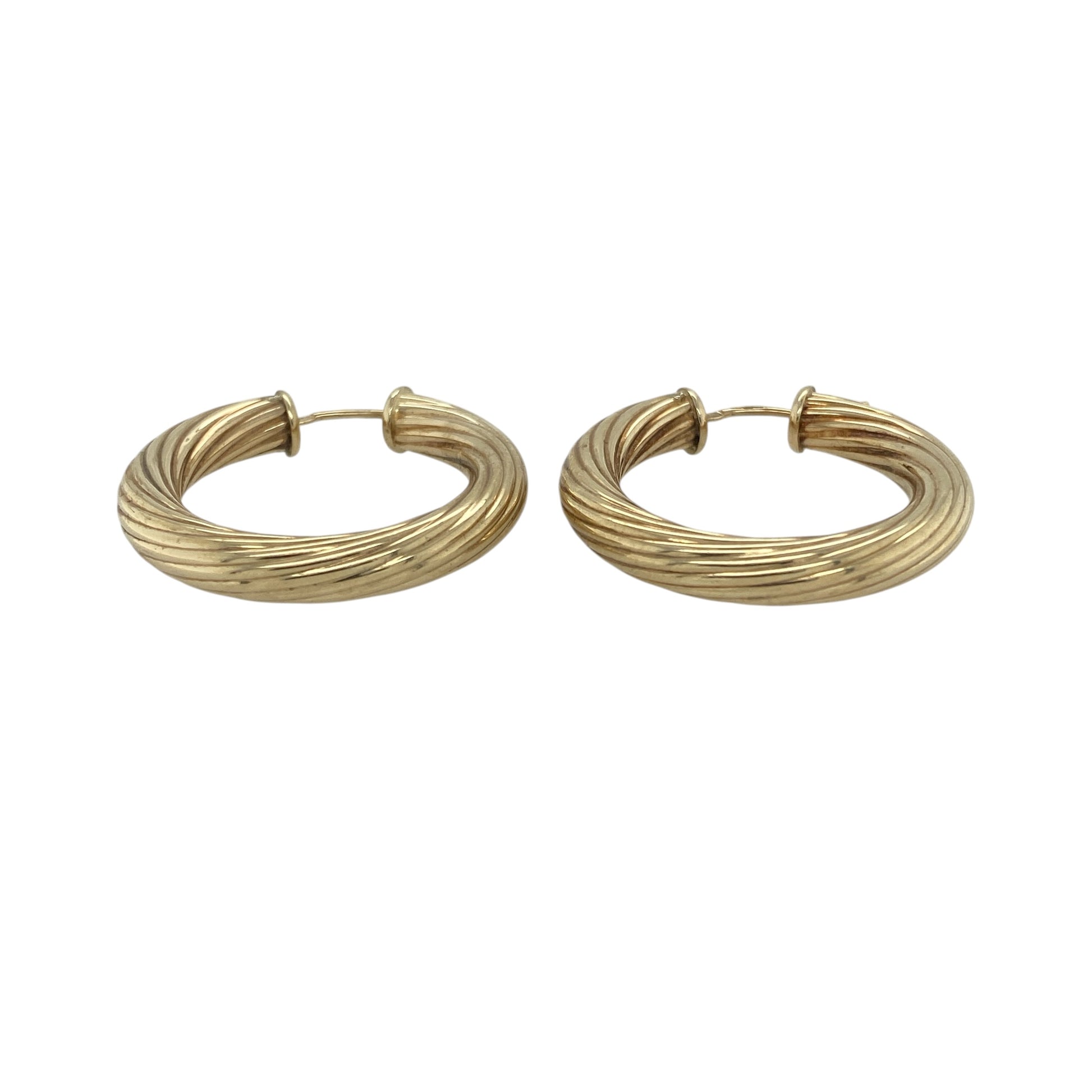 Add bold style and classic texture to your collection with these pre-owned 9ct yellow gold twisted hoop creole earrings—an eye-catching pair with a timeless yet striking design.

Design: The earrings feature a traditional hoop creole shape with a twisted pattern, creating depth and movement that catches the light beautifully for added shine.
Material: Made from 9-carat yellow gold, the polished finish enhances the warmth of the metal while highlighting the twist detail.