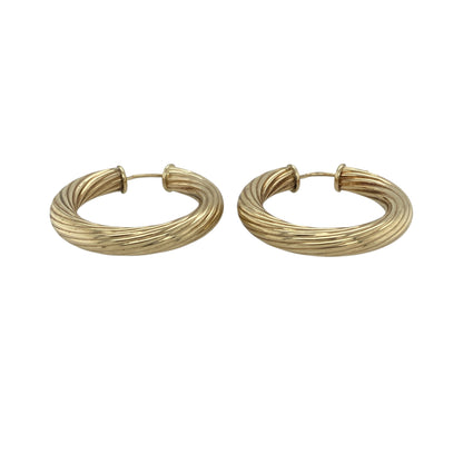 Add bold style and classic texture to your collection with these pre-owned 9ct yellow gold twisted hoop creole earrings—an eye-catching pair with a timeless yet striking design.

Design: The earrings feature a traditional hoop creole shape with a twisted pattern, creating depth and movement that catches the light beautifully for added shine.
Material: Made from 9-carat yellow gold, the polished finish enhances the warmth of the metal while highlighting the twist detail.