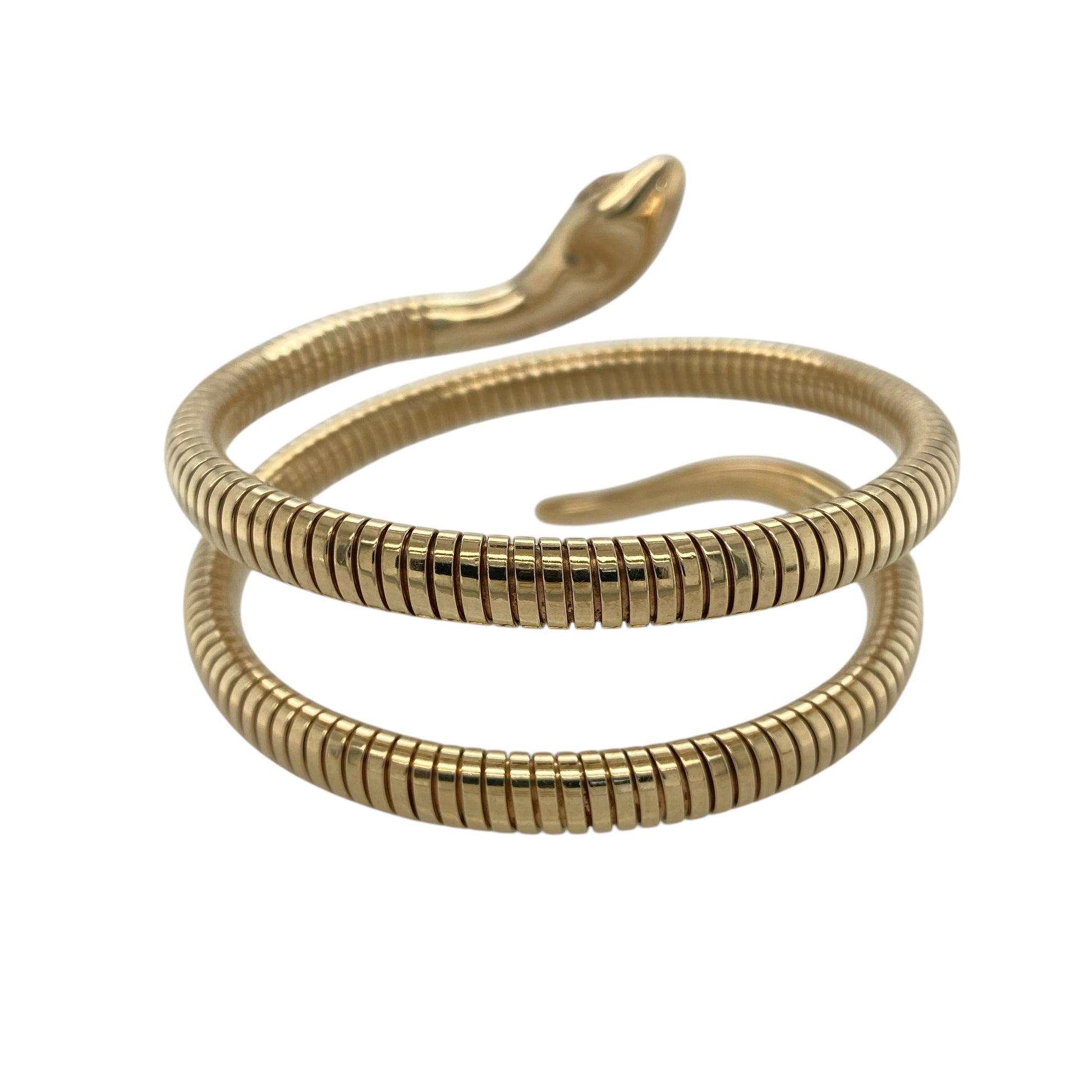 Make a bold and distinctive statement with this pre-owned 9ct yellow gold ruby set snake wrap around bangle—an eye-catching piece that blends symbolism with striking design.

Design: The bangle is styled as a coiled snake that wraps around the wrist or can be worn higher on the arm, with ruby gemstones forming the eyes for a vivid and captivating detail. Its flexible structure allows it to gently adjust for a comfortable and secure fit.