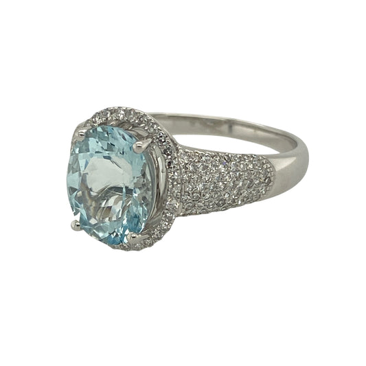 Add elegant sparkle and serene colour to your collection with this pre-owned 9ct white gold diamond and aquamarine set halo ring—an eye-catching piece with timeless appeal.

Design: The ring features a striking 10mm by 8mm oval aquamarine centre stone, surrounded by a halo of sparkling diamonds, with additional diamonds set along the shoulders for enhanced brilliance and a luxurious finish.