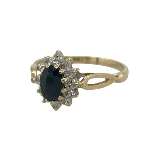 Add timeless elegance and classic sparkle to your collection with this pre-owned 9ct yellow gold diamond and sapphire set cluster ring—an effortlessly stylish piece with enduring appeal.

Design: The ring features a 6mm by 4mm oval sapphire at the centre, surrounded by a cluster of sparkling diamonds that enhance the rich blue tone and create a bright, eye-catching focal point.