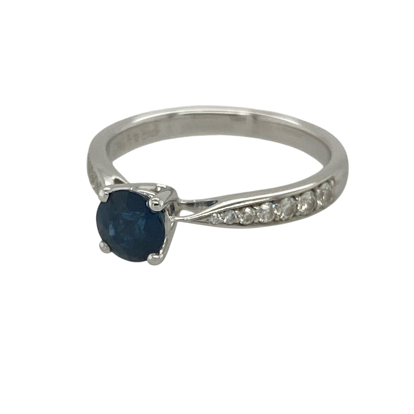 Add timeless elegance and rich colour to your collection with this pre-owned 18ct white gold diamond and sapphire set ring—an elegant piece that blends classic design with refined sparkle.

Design: The ring features a 5mm diameter round sapphire at the centre, complemented by sparkling diamonds set along the shoulders, creating a balanced and eye-catching look.
