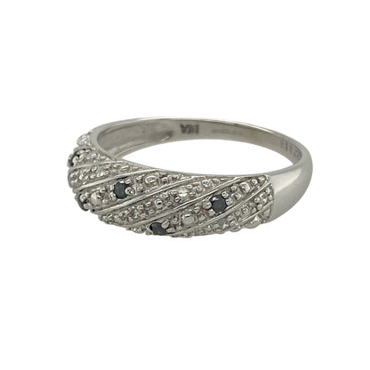 Add striking contrast and contemporary style to your collection with this pre-owned 9ct white gold white and black diamond set twisted band ring—an eye-catching piece with modern appeal.

Design: The ring features a twisted band style with a 6mm wide front, set with a mix of white and black diamonds that create a bold and distinctive contrast.