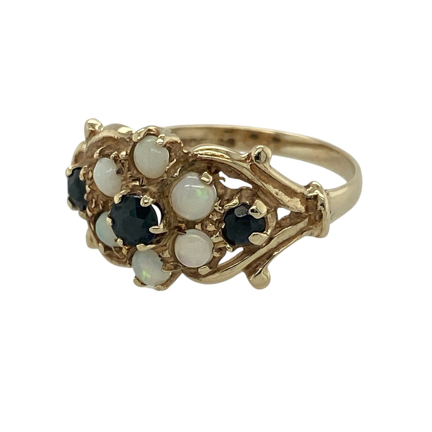 Add vintage charm and soft iridescent colour to your collection with this pre-owned 9ct yellow gold opalique and sapphire set flower ring—an elegant piece with a delicate floral design.

Design: The ring features a flower-inspired cluster measuring approximately 11mm in height, combining opalique stones with sapphire accents to create a beautiful blend of shimmer and rich blue tones.
