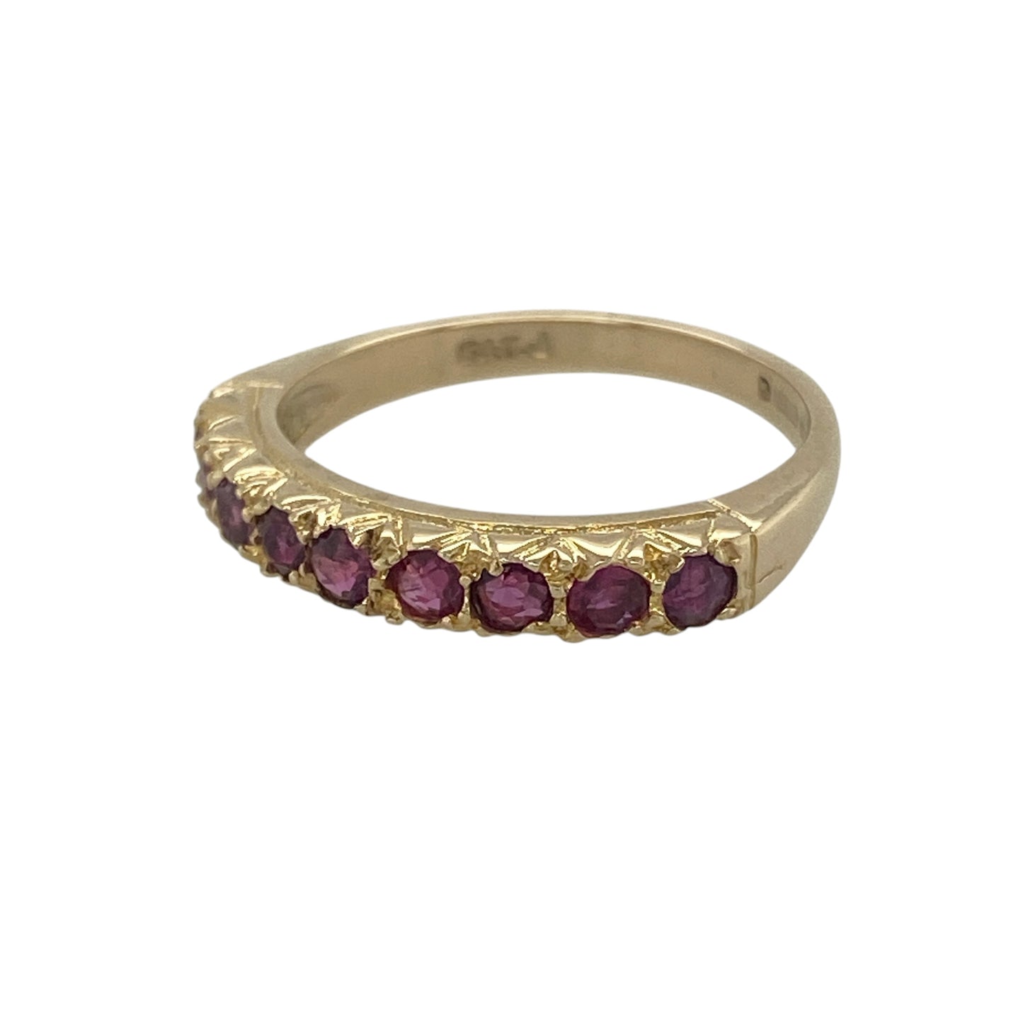 Add rich colour and timeless elegance to your collection with this pre-owned 9ct yellow gold ruby set band ring—an eye-catching piece perfect for everyday wear or stacking.

Design: The ring features nine round ruby gemstones, each approximately 2mm in diameter, arranged across the band to create a vibrant and balanced display of deep red colour.
Material: Made from 9-carat yellow gold, the polished finish enhances the warmth of the metal while complementing the rich tones of the rubies.