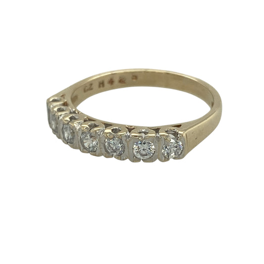 Add classic sparkle and everyday elegance to your collection with this pre-owned 9ct yellow gold cubic zirconia set band ring—an effortlessly stylish piece with timeless appeal.

Design: The ring features seven round cubic zirconia stones, each approximately 2mm in diameter, arranged across the band to create a bright and balanced line of sparkle.
Material: Made from 9-carat yellow gold, the polished finish enhances the warmth of the metal while complementing the brilliance of the stones.