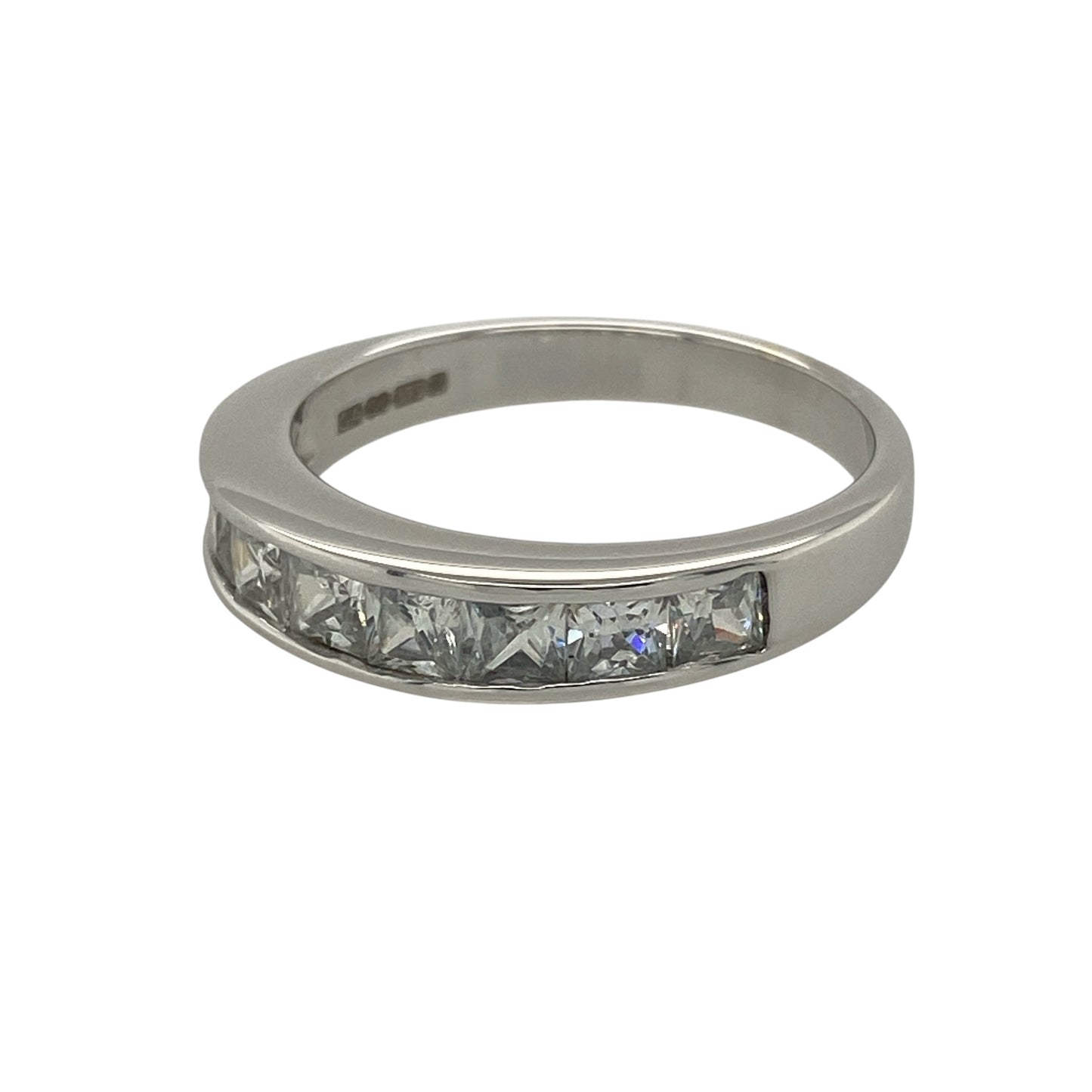 Add modern sparkle and clean lines to your collection with this pre-owned 9ct white gold cubic zirconia set band ring—an elegant piece with a contemporary edge.

Design: The ring features a 4mm wide front set with princess-cut cubic zirconia stones, creating a sleek and structured look with sharp, reflective facets.
Material: Made from 9-carat white gold, the polished finish enhances the cool tone of the metal while complementing the brilliance of the cubic zirconia.